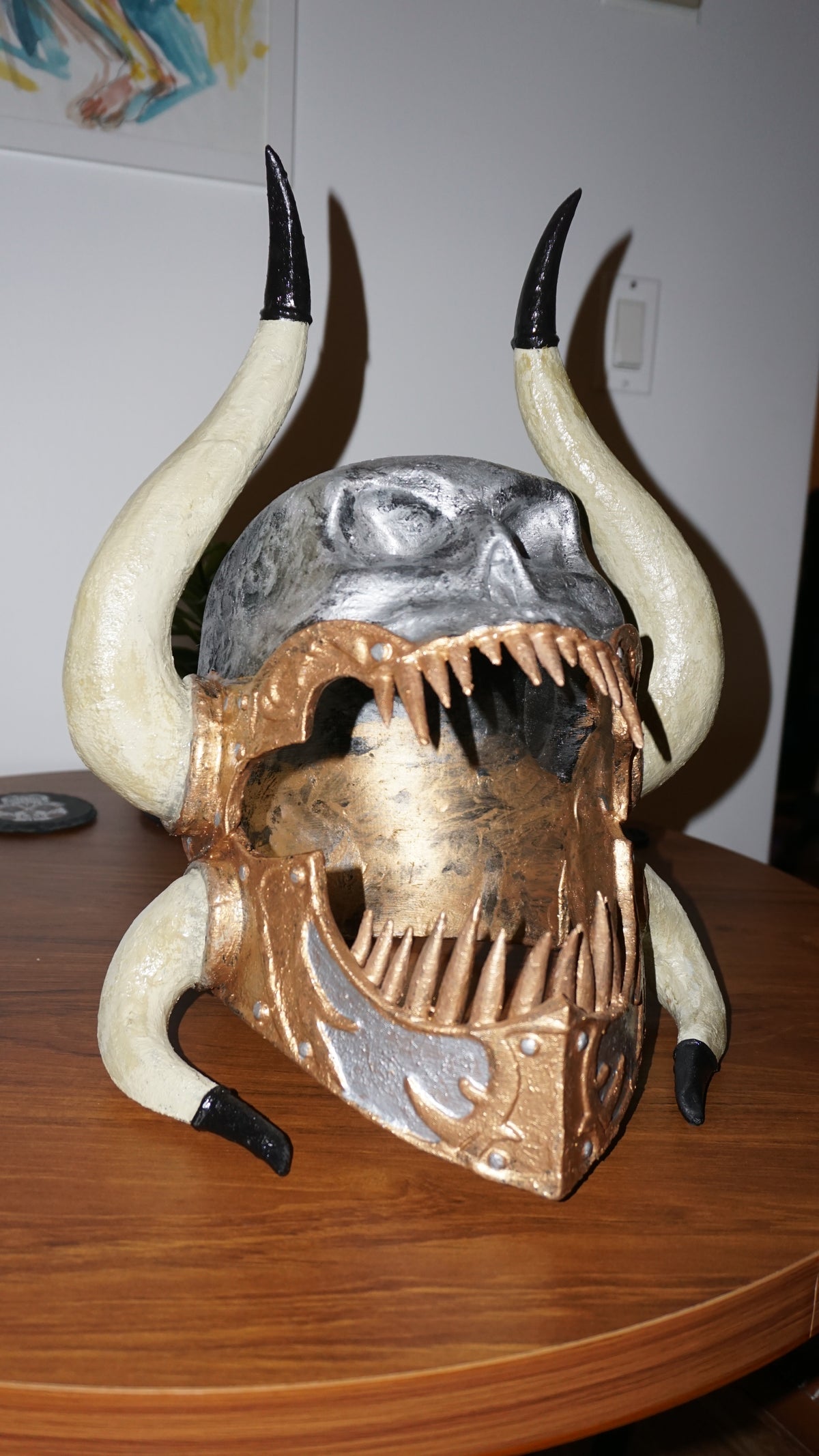 a unique and intricate sculpture of a skull with horns, which appears to be a work of art or a decorative piece.